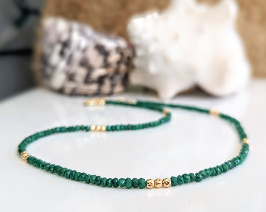 Stunning emerald bead necklace with golden accents, symbolizing love and friendship, perfect for May birthdays.