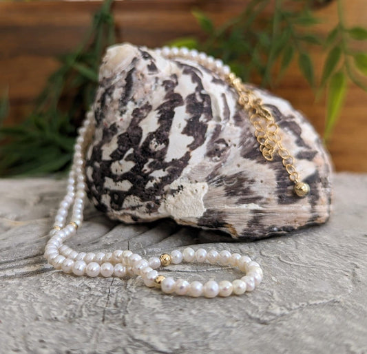 Handmade freshwater pearl necklace resting on a unique seashell, showcasing elegance for weddings and special occasions.