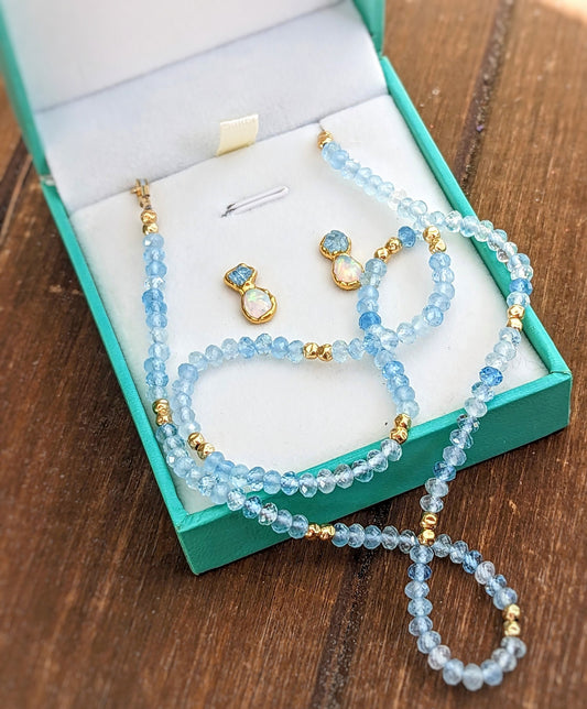 Aquamarine and Opal bridal jewelry set in a teal box, featuring bead necklace and stud earrings.