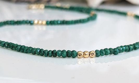 Emerald bead necklace with gold accents, symbolizing love and friendship, perfect for May birthdays and meaningful gifts.