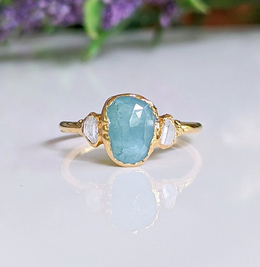 Aqua blue Grandidierite and diamond ring in 18k gold, featuring a rose cut gemstone and Herkimer diamonds.