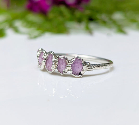 Handcrafted raw pink Sapphire Eternity ring on a silver band, featuring 5-7 raw pink sapphires.