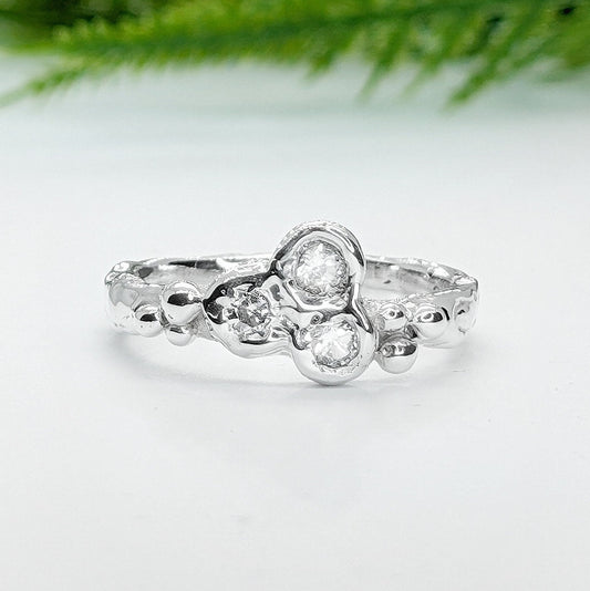 Silver CZ Cluster ring showcasing a handcrafted organic molten band and dazzling cubic zirconia stones.