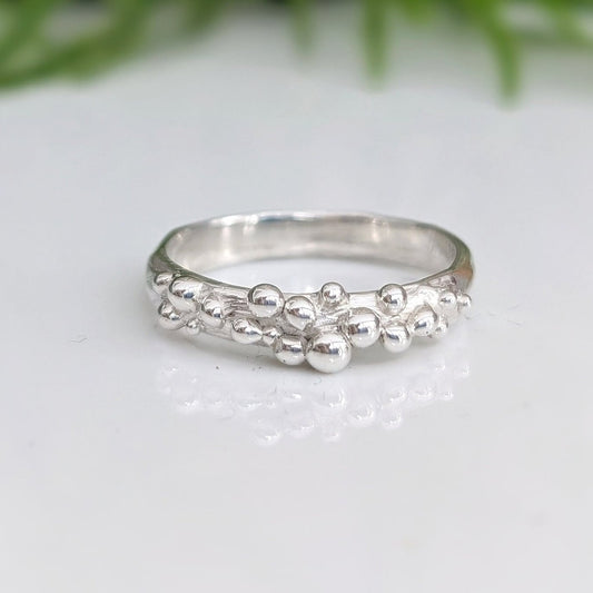 Dew Drop beaded textured silver ring showcasing unique handcrafted design with irregular abstract form.