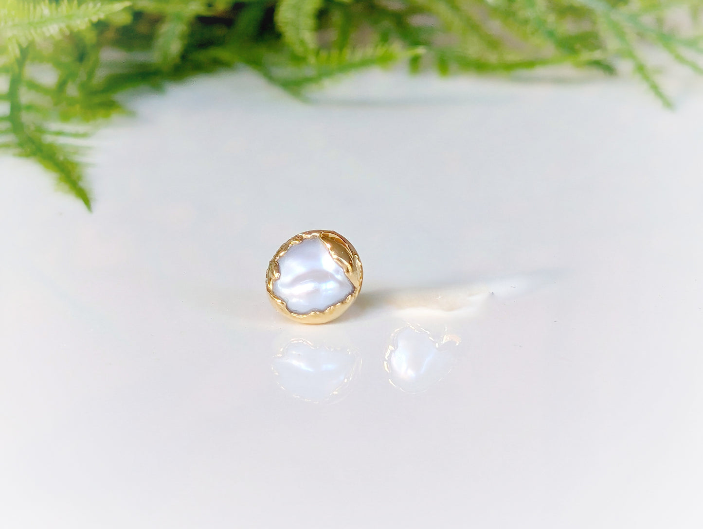 a close up of a ring on a white surface