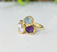 Custom family birthstone ring in gold with raw gemstones, representing loved ones' birthstones, unique heirloom jewelry.