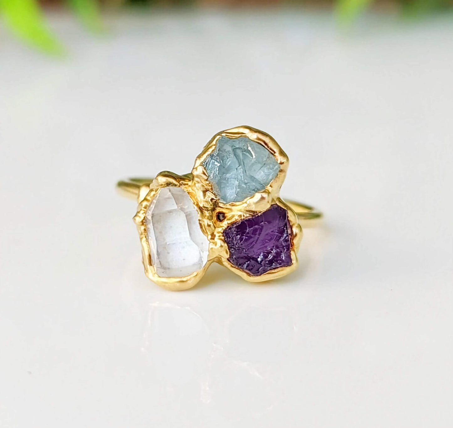 Custom family birthstone ring featuring raw gemstones in gold settings, perfect heirloom gift for loved ones.