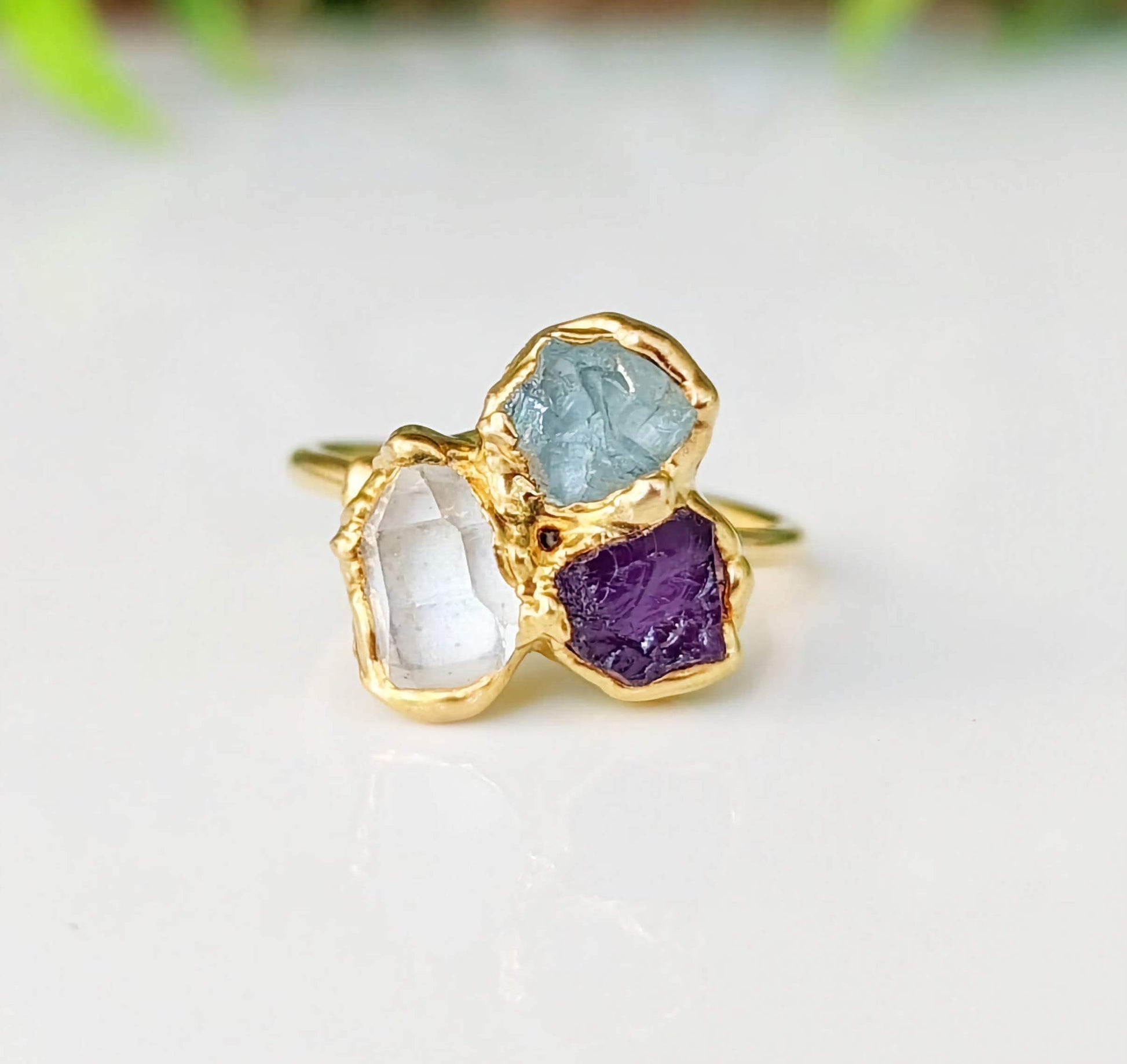 Custom family birthstone ring featuring raw gemstones in gold settings, perfect heirloom gift for loved ones.