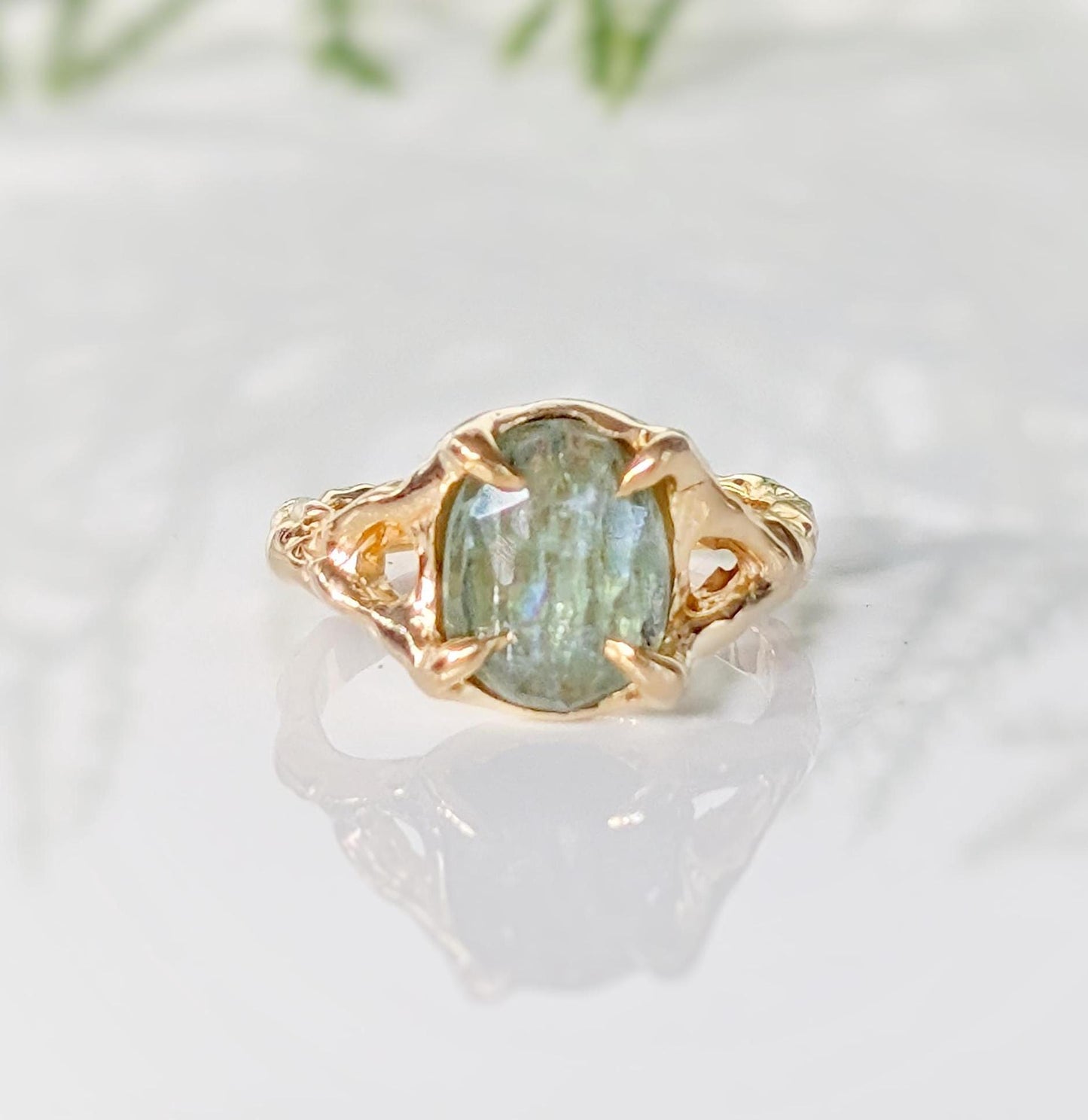 Solid 14k Gold textured ring featuring an oval Lime green Kyanite stone, showcasing unique artistry and elegance.