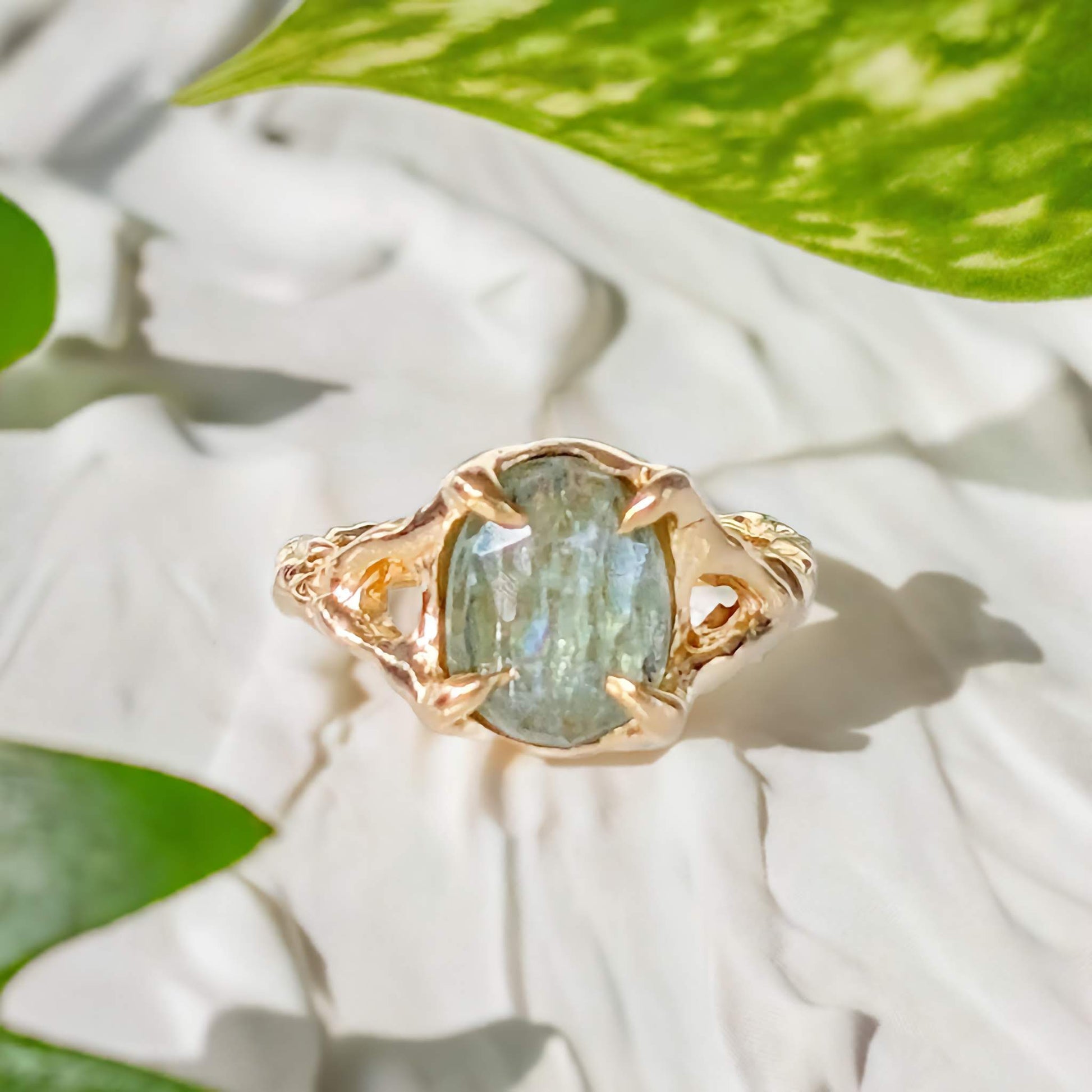 Solid 14k Gold textured ring featuring a stunning oval rose cut Green Kyanite on a natural background.
