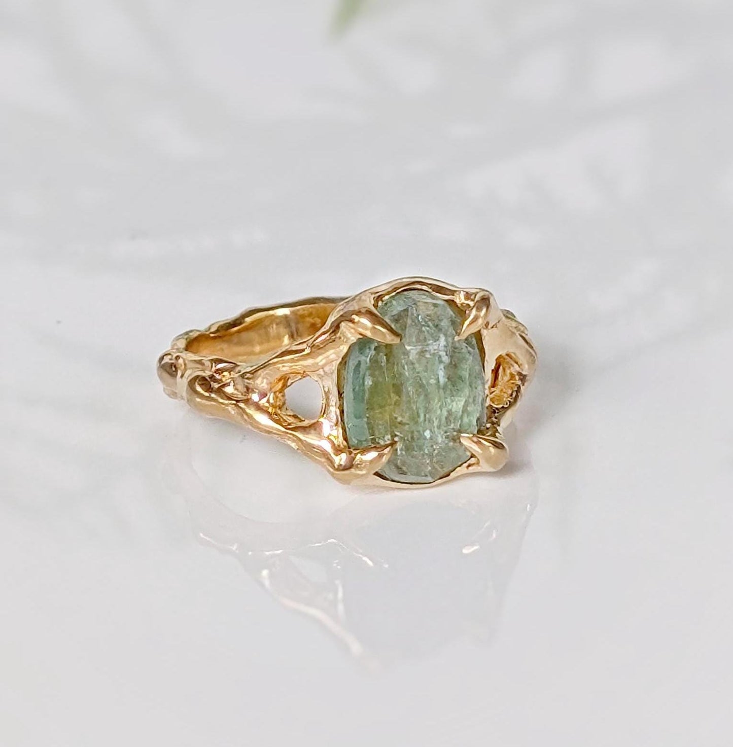 Solid 14k Gold textured ring featuring an oval-shaped green Kyanite gemstone on a unique organic band.
