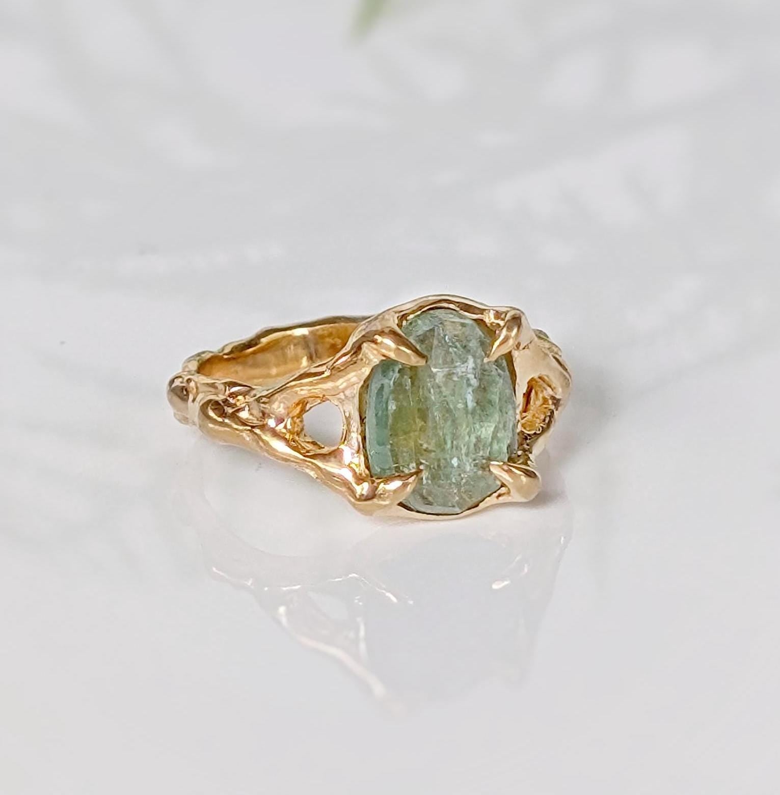 Solid 14k Gold textured ring featuring an oval-shaped green Kyanite gemstone on a unique organic band.
