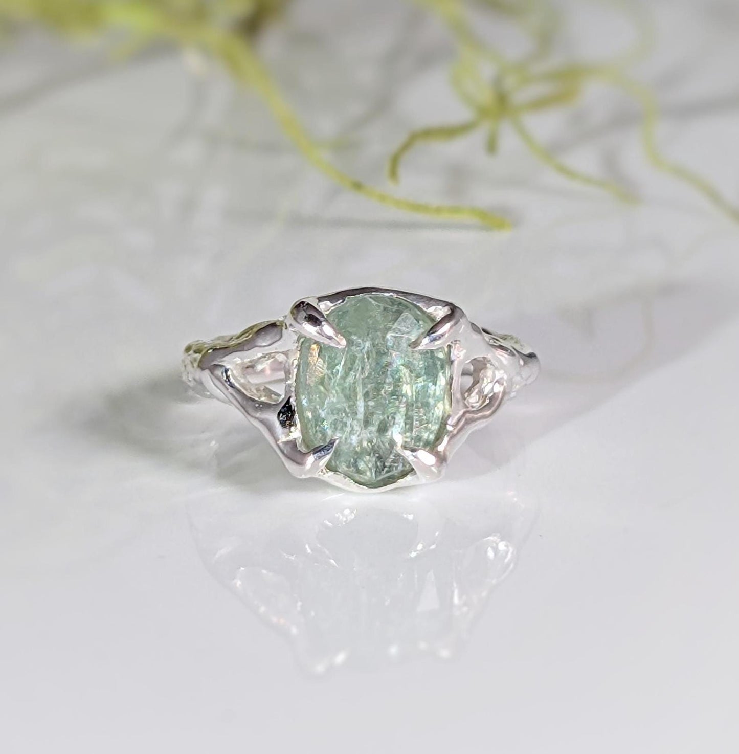 Sterling Silver ring featuring oval rose cut green Kyanite with organic textured band, showcasing unique elegance.