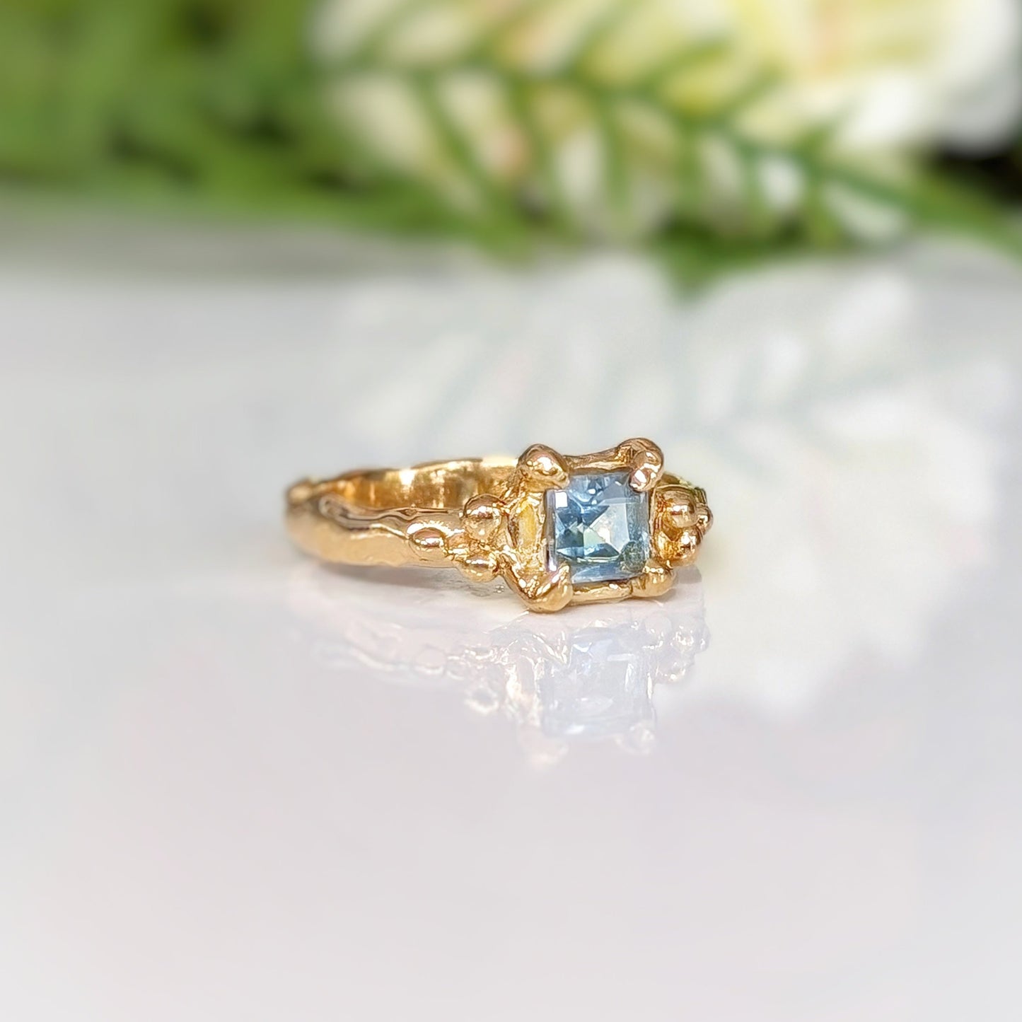 Square Blue topaz set on a Molten Gold textured band