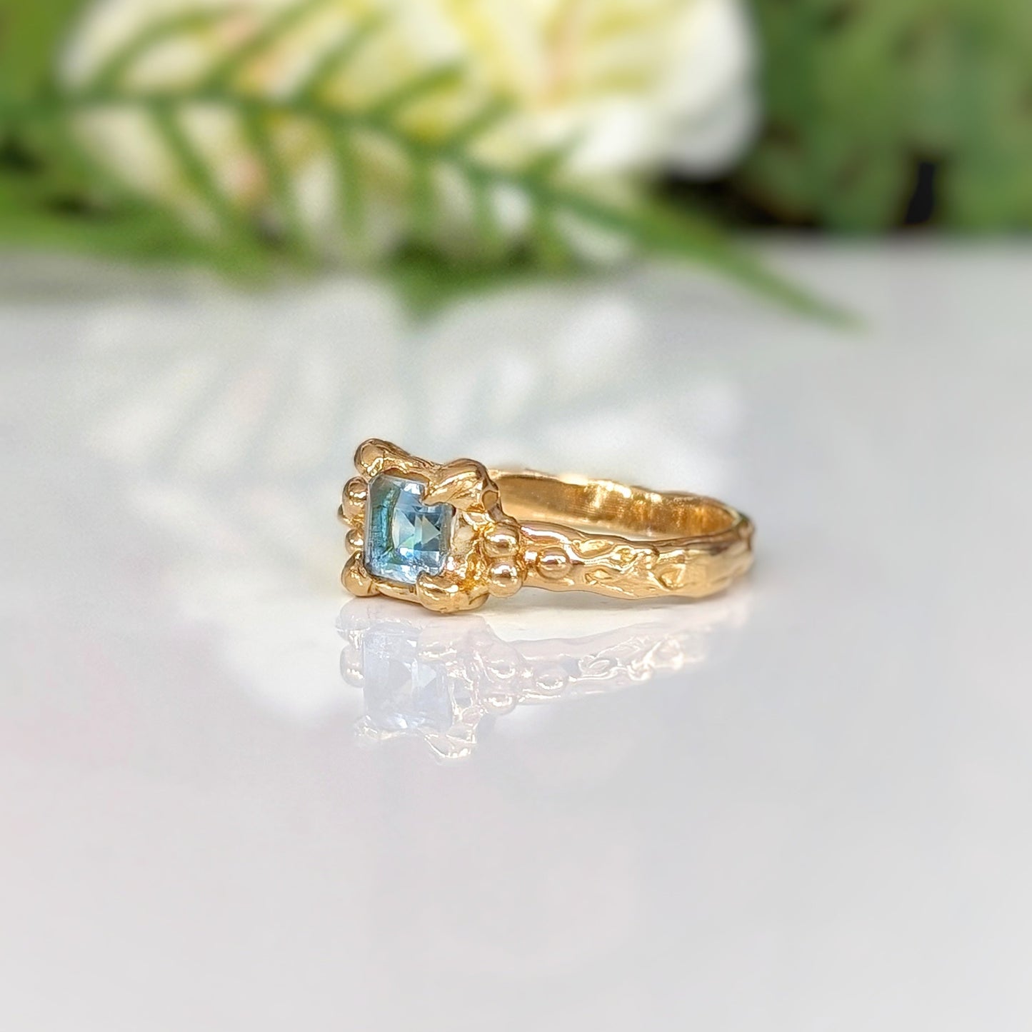 Square Blue topaz set on a Molten Gold textured band