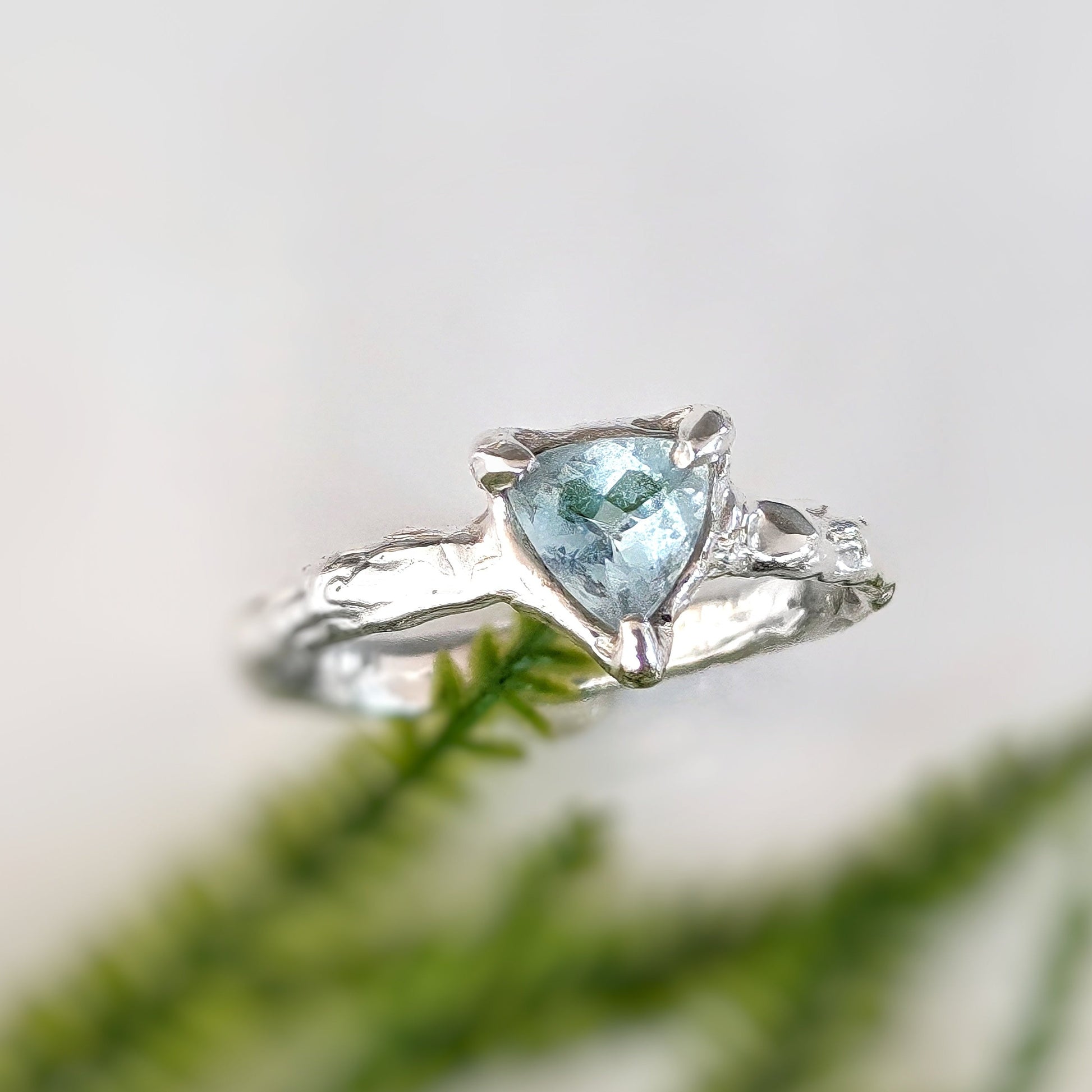 Trilliant shape Aquamarine set by prongs in organic Solid Sterling Silver band