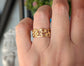 Woman's hand wearing a Molten Solid 14k Gold Honeycomb ring
