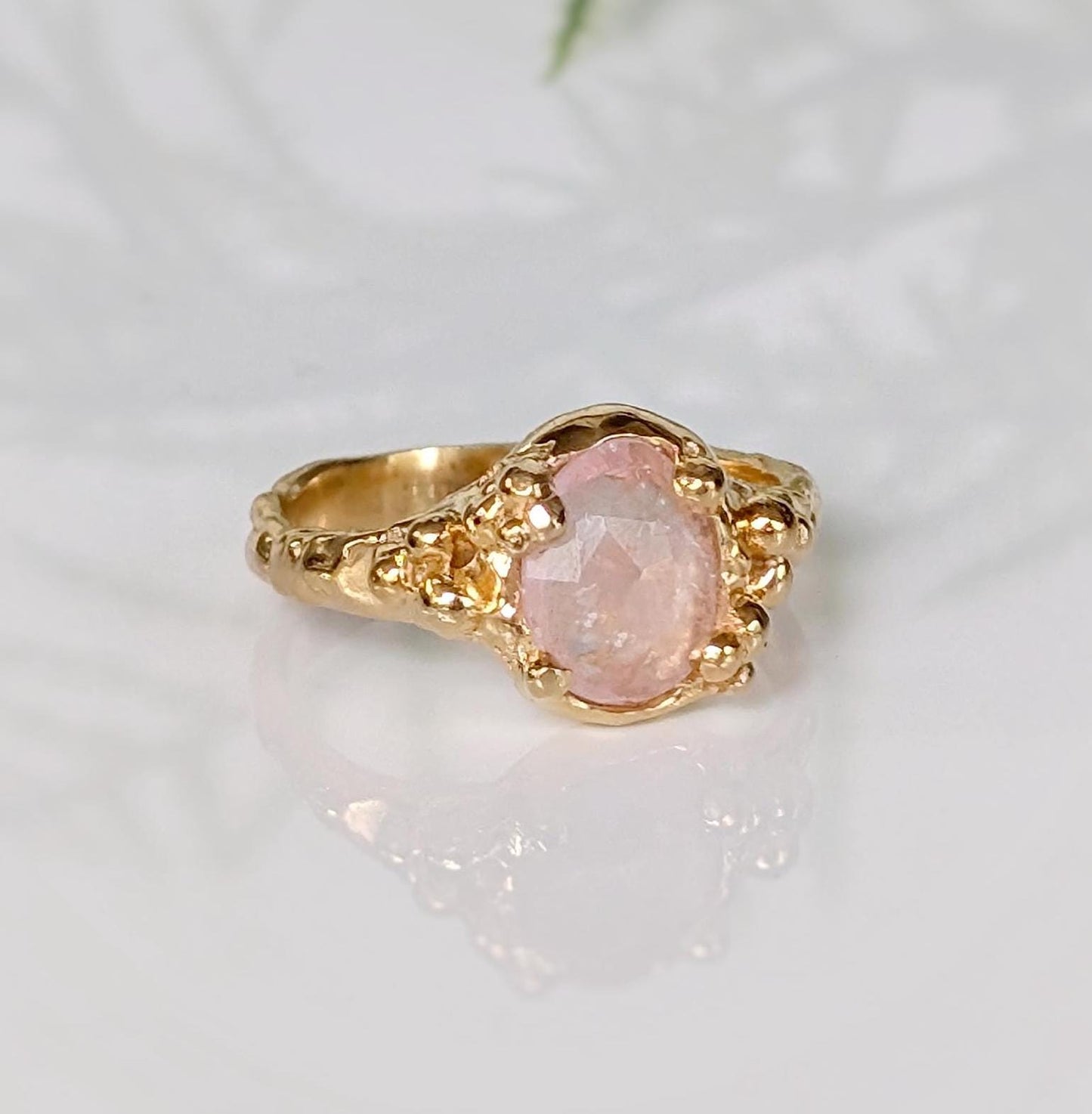 Handcrafted pink Morganite ring in solid 14k gold, featuring oval rose cut gemstone and textured band.