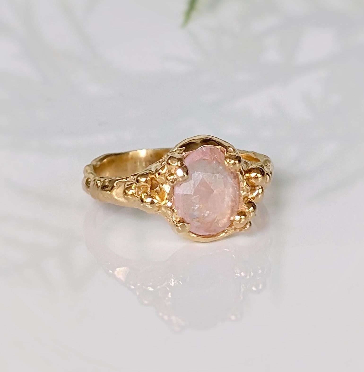 Handcrafted pink Morganite ring in solid 14k gold, featuring oval rose cut gemstone and textured band.