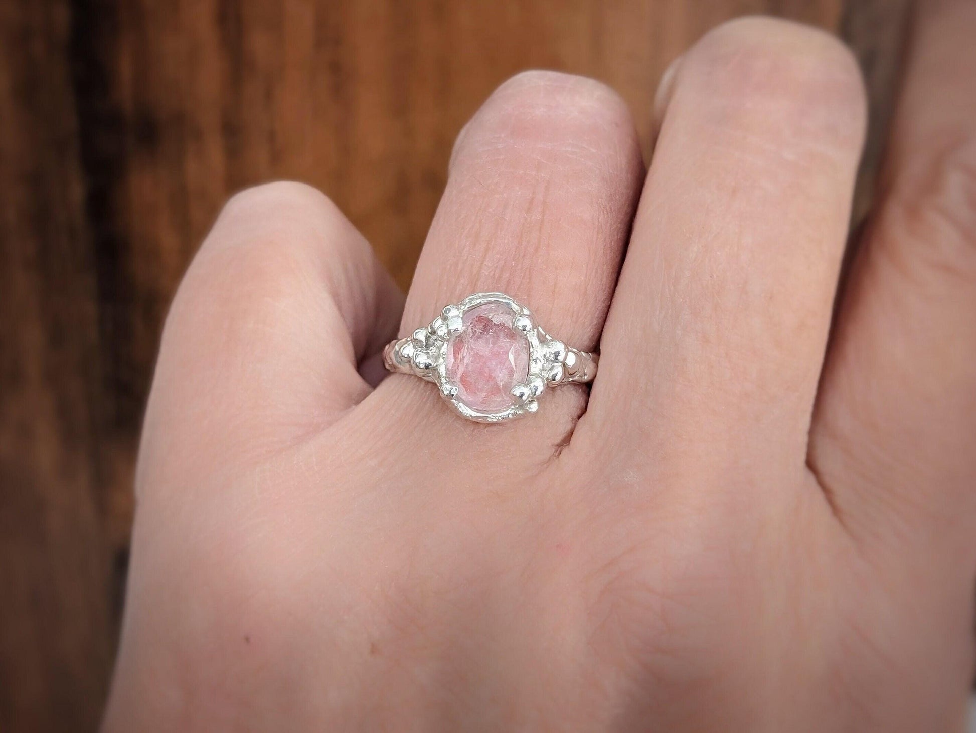 Handcrafted pink Morganite ring set in solid gold, showcasing an oval rose cut stone and delicate band design.