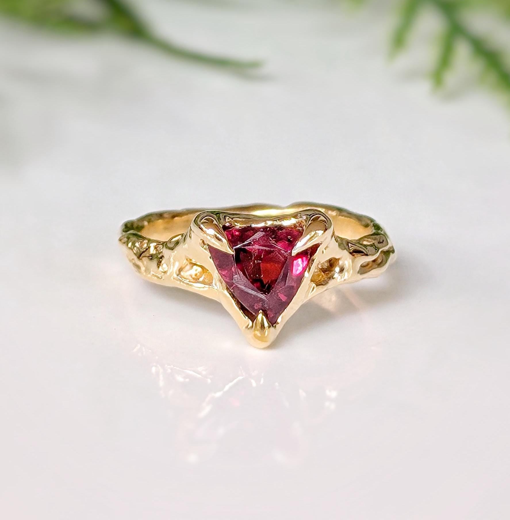 Rubellite Tourmaline textured ring in solid 14k gold with an organic band and a striking dark pink gemstone.