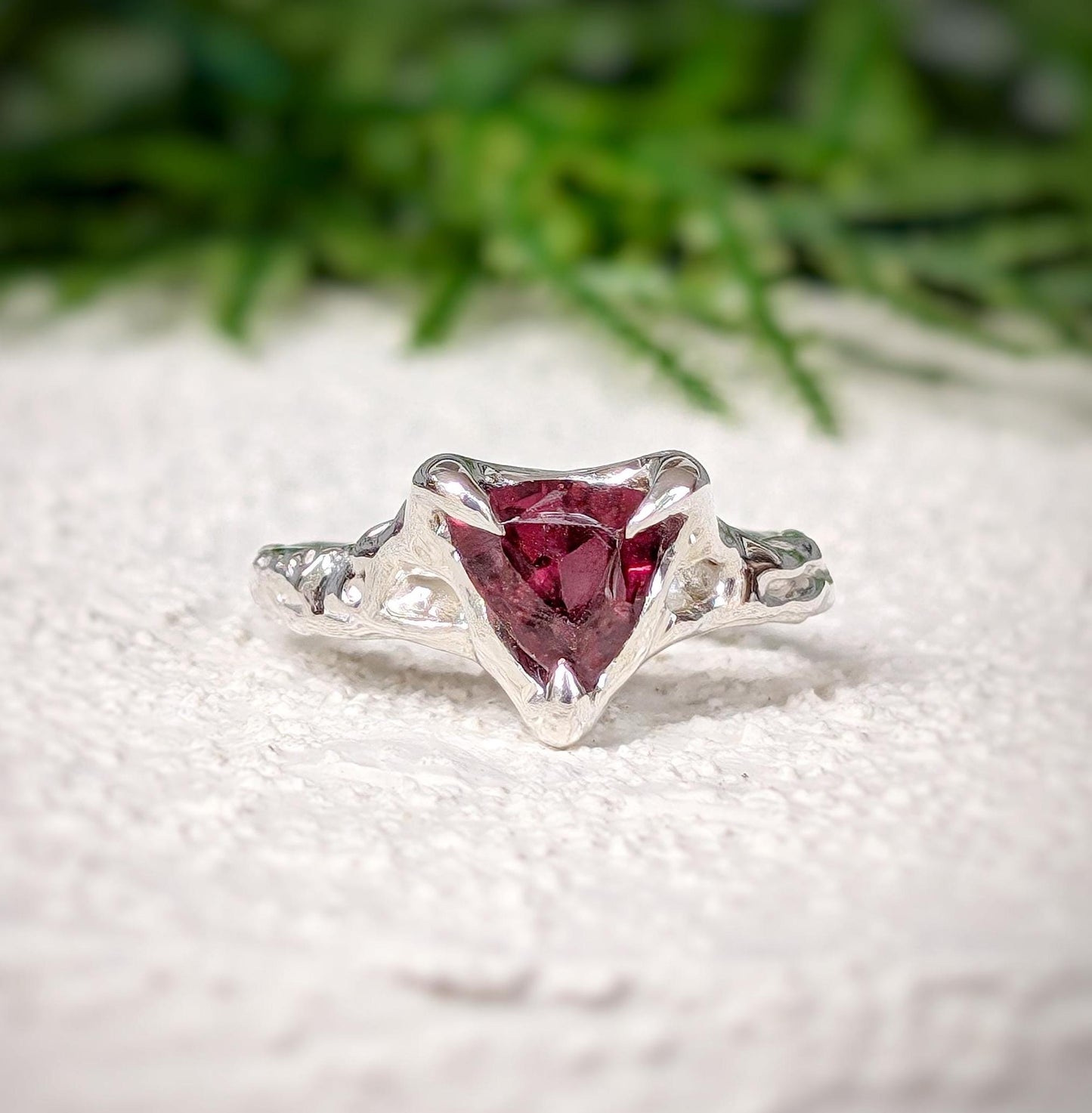 Handcrafted Sterling Silver textured ring featuring a dark pink Rubellite Tourmaline in trilliant cut design.