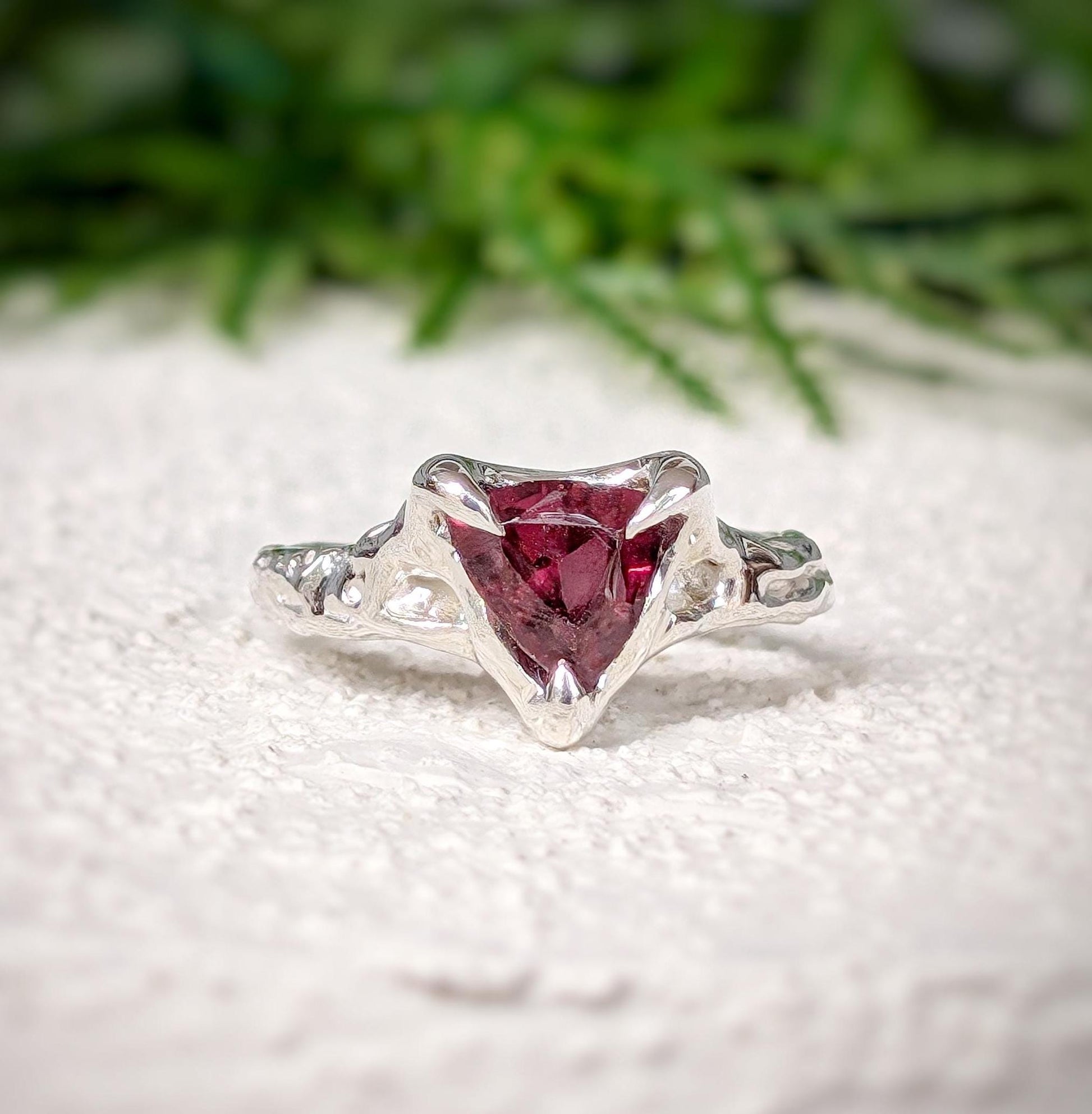 Handcrafted Sterling Silver textured ring featuring a dark pink Rubellite Tourmaline in trilliant cut design.