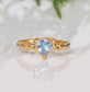 Solid Gold Aquamarine ring with textured band, featuring a unique triangular blue crystal centerpiece.