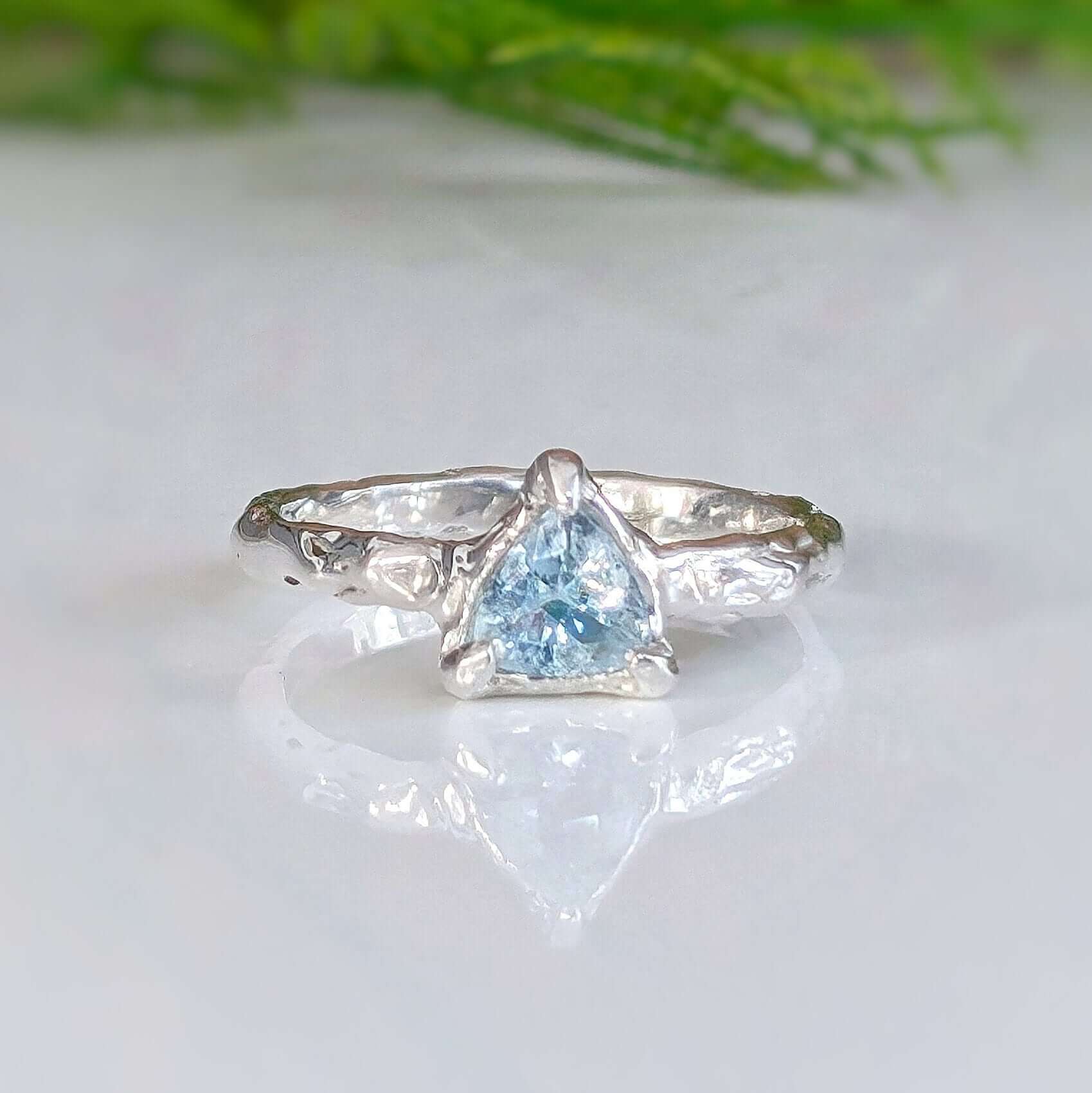 Handcrafted Solid Silver Aquamarine ring with textured band, featuring a stunning blue gemstone.