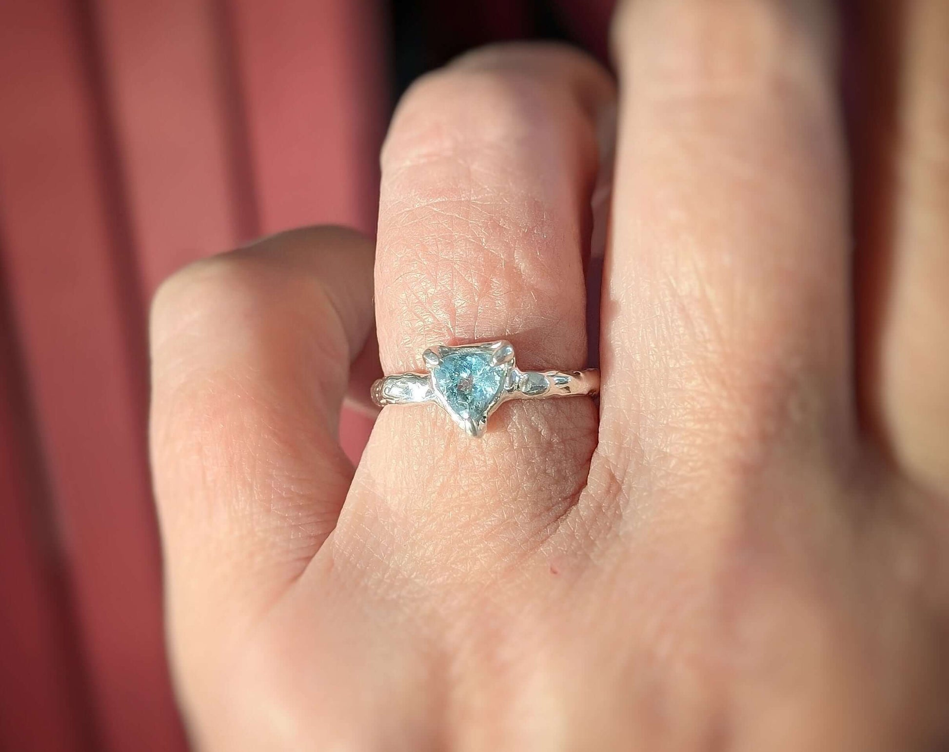 Solid Gold Aquamarine ring with unique blue crystal on a textured band, perfect for engagements or special gifts.
