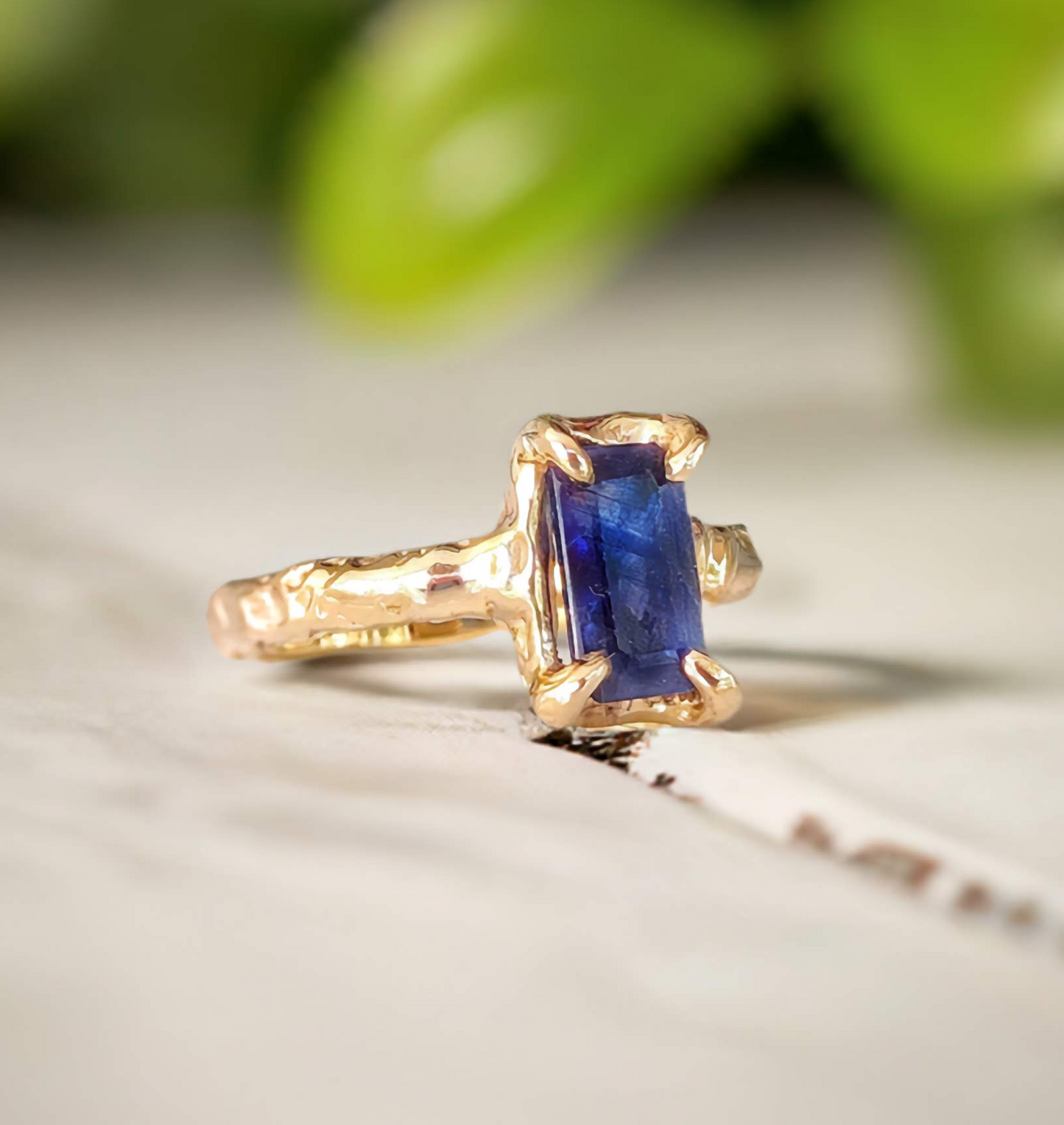 a gold ring with a blue sapphire stone