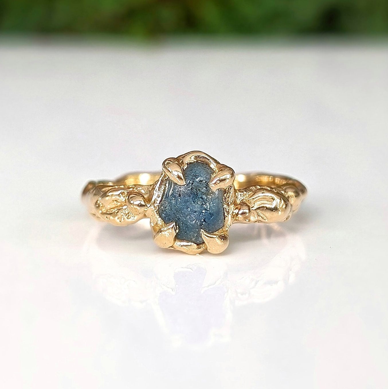 Raw Montana Sapphire set by prongs on a Molten Solid 14k Gold textured band