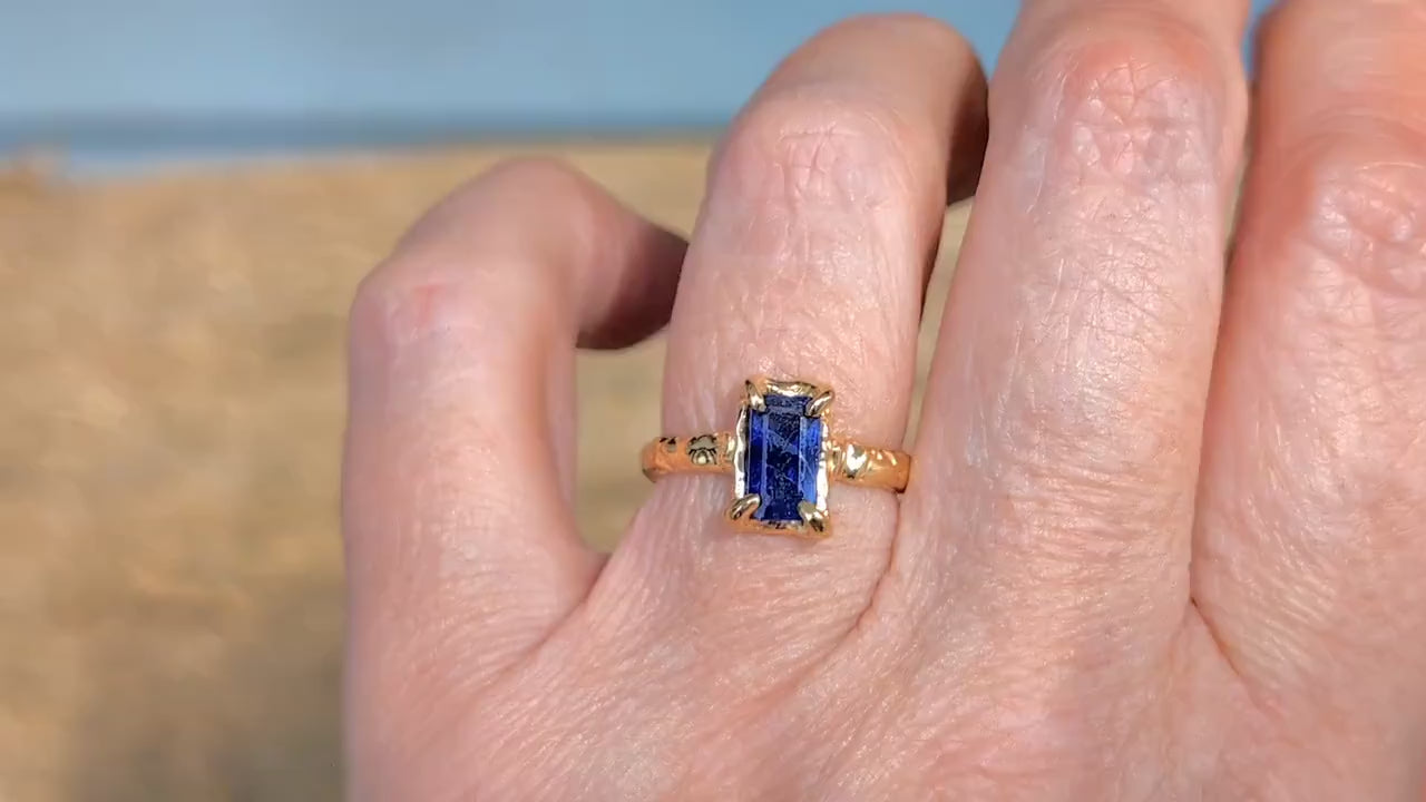 A rectangular Blue Sapphire ring set by prongs on a textured Molten Solid 14k Gold band