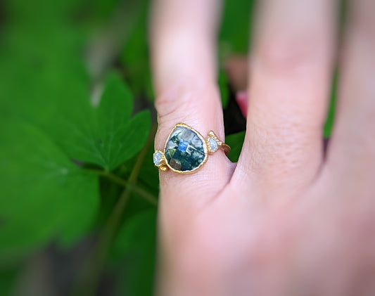 Pear-shaped Moss Agate and raw diamond ring in silver, showcasing rustic elegance and nature-inspired beauty.