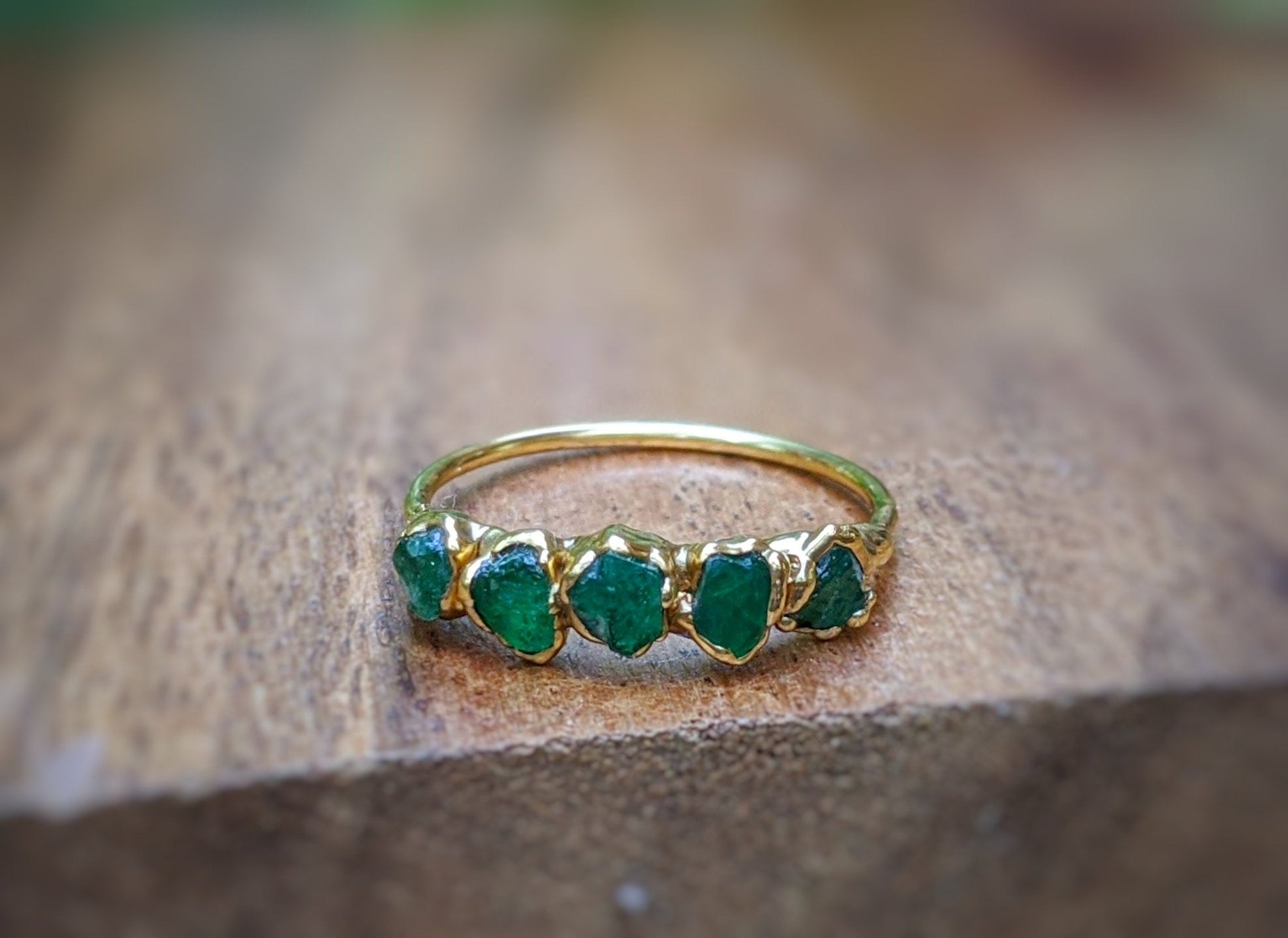 Raw Emerald half Eternity ring uniquely set in 18k Gold 
