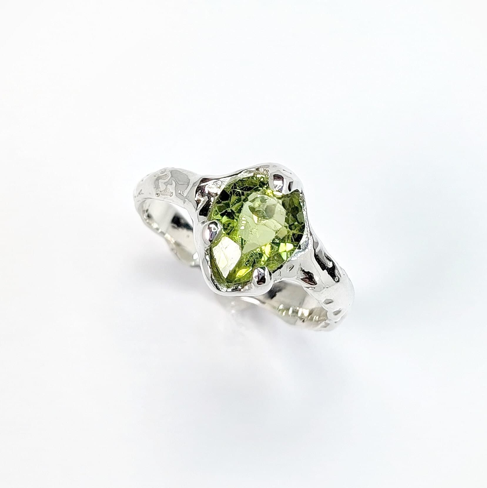 Large Pear shape Peridot set by prongs on a textured Molten Solid Sterling Silver band