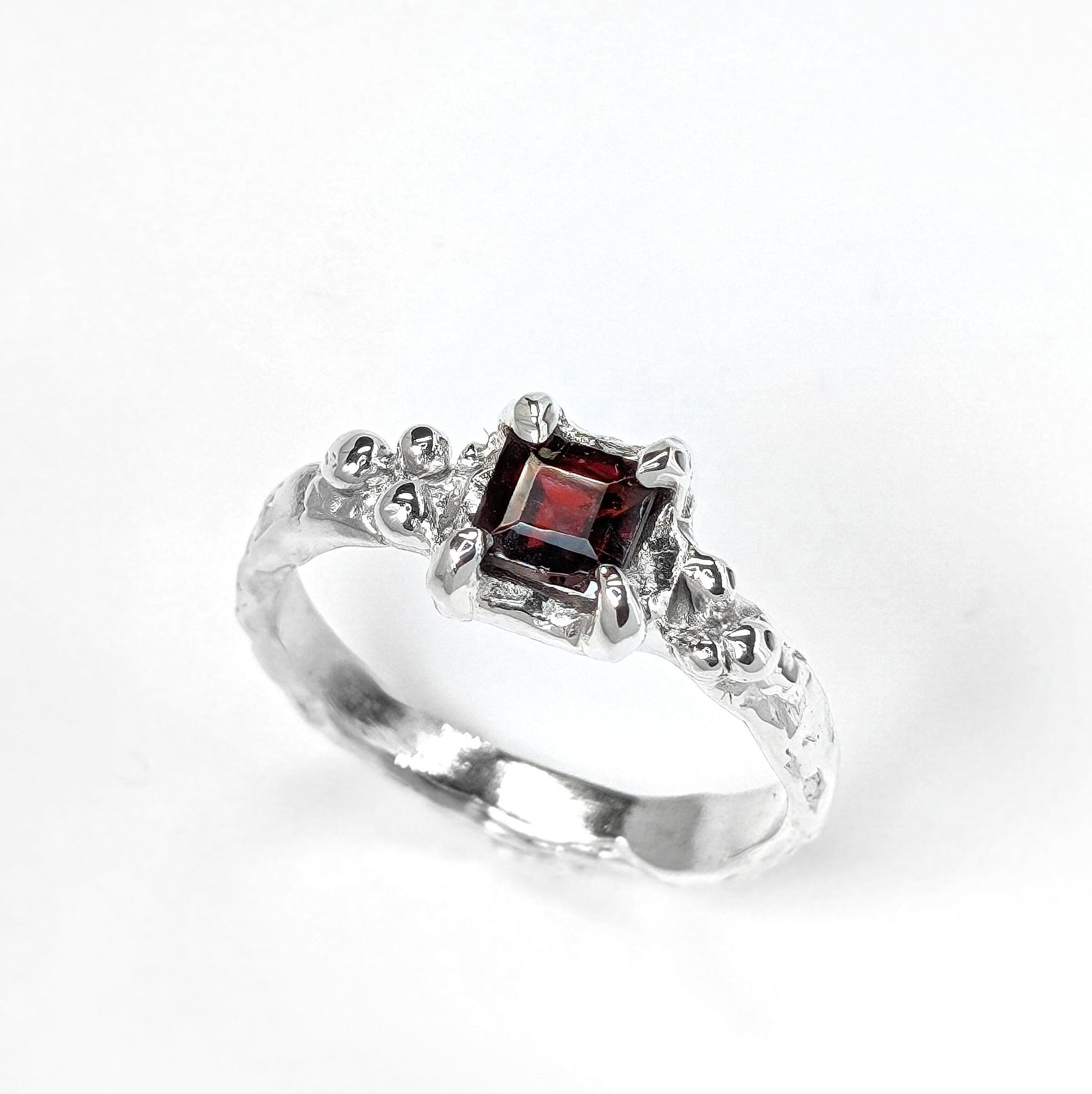 Square Red Garnet set on a Molten Silver textured band