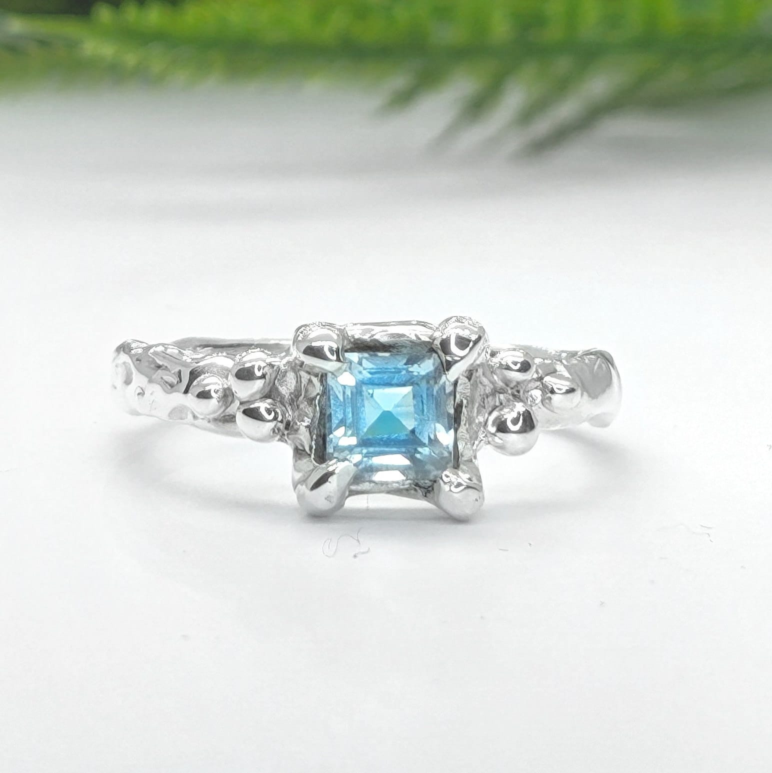 Square Blue Topaz set by prongs on a textured Molten Solid Sterling Silver band