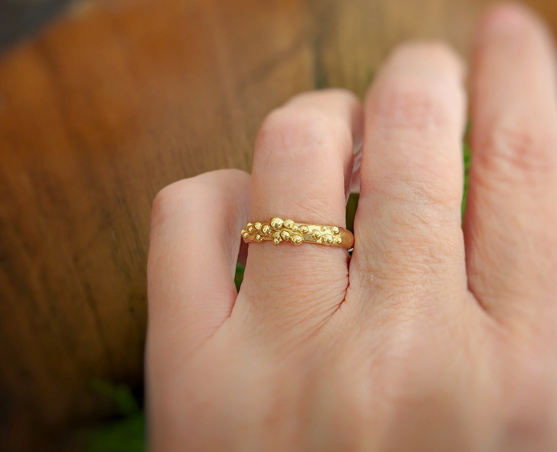 Molten Solid 14k Gold granulated and textured ring on a hand