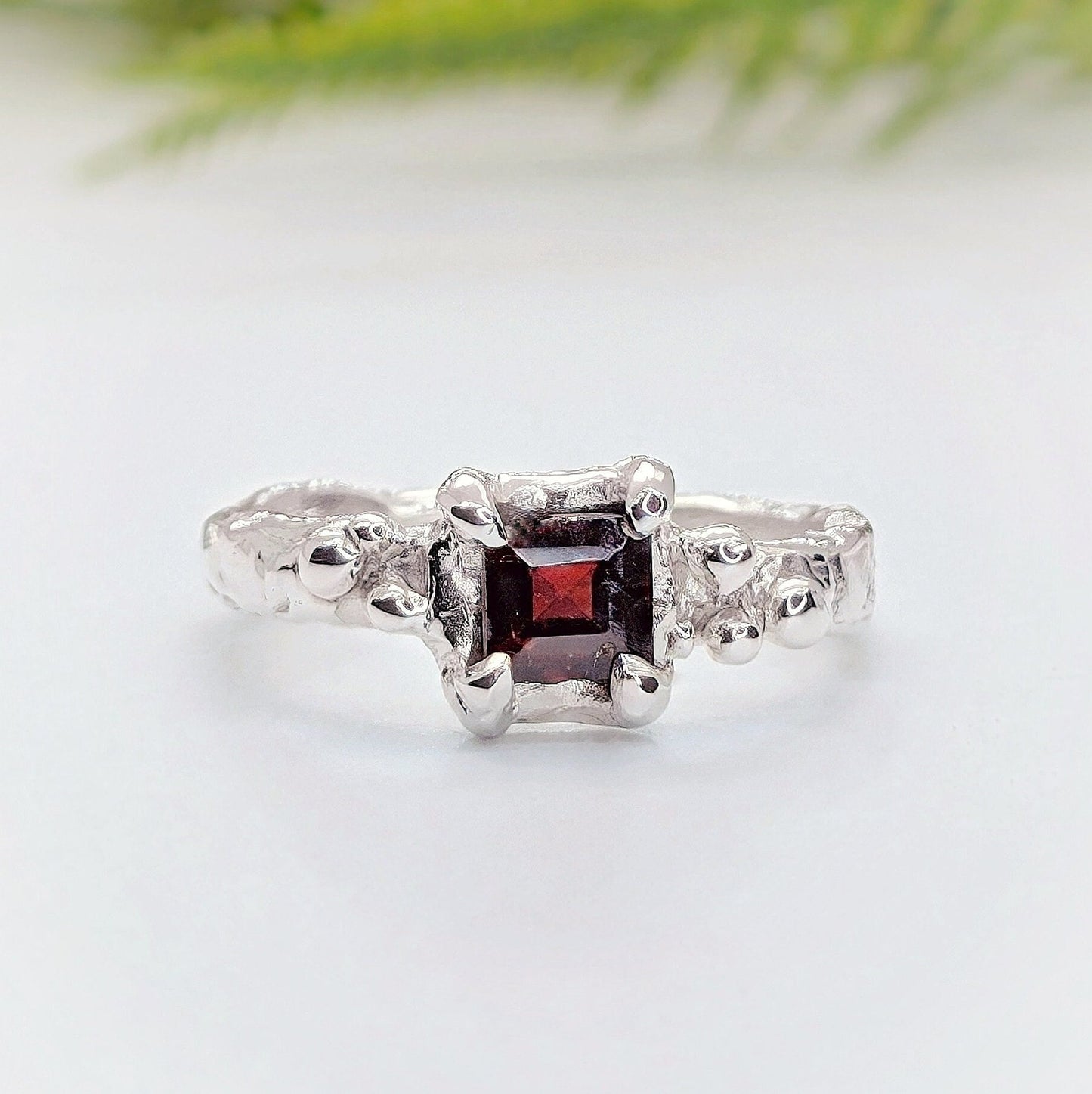 Red square Garnet set by prongs on a Solid Sterling Silver Molten textured band