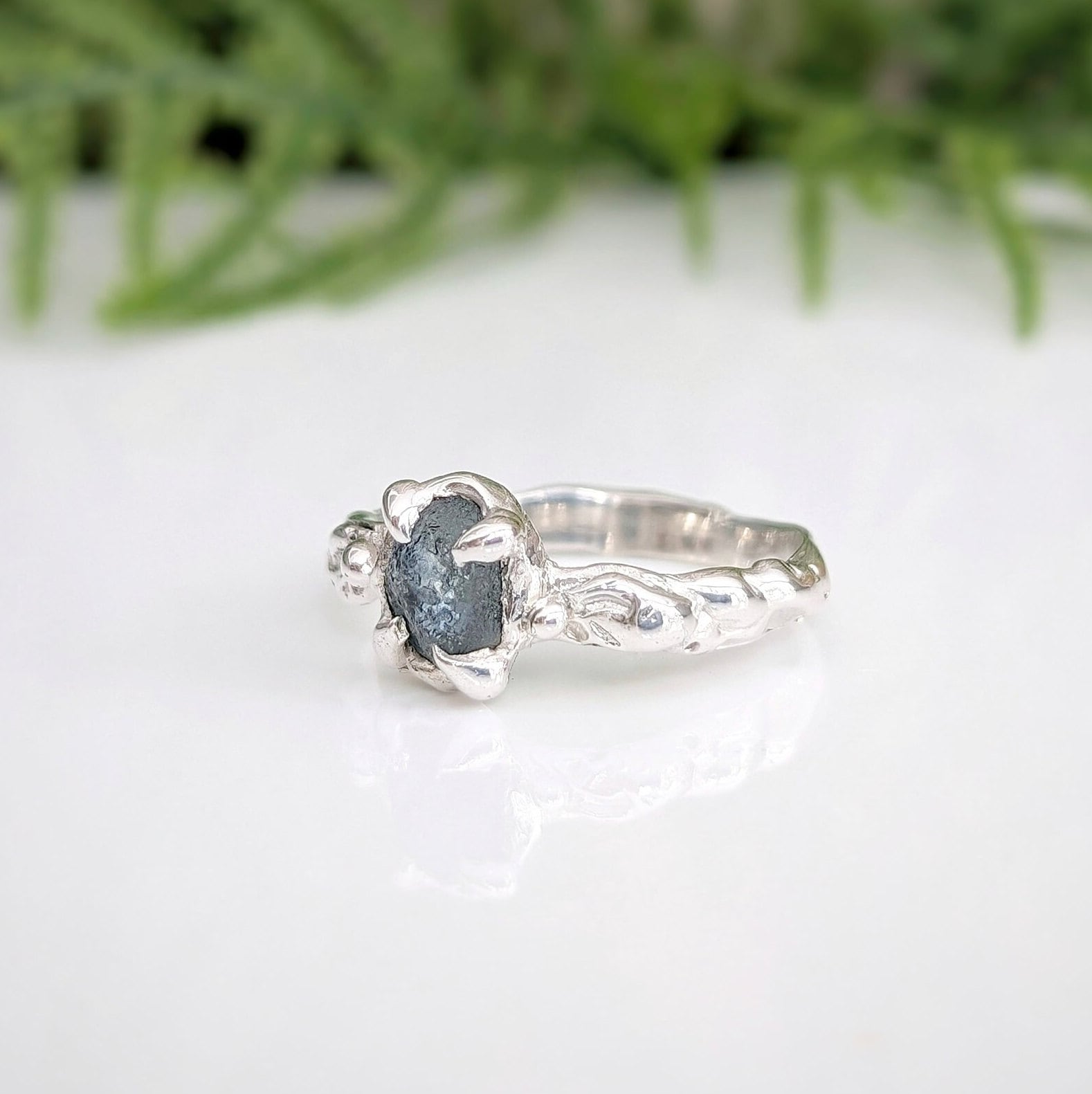 Raw Montana Sapphire set by prongs on a Molten Silver textured band