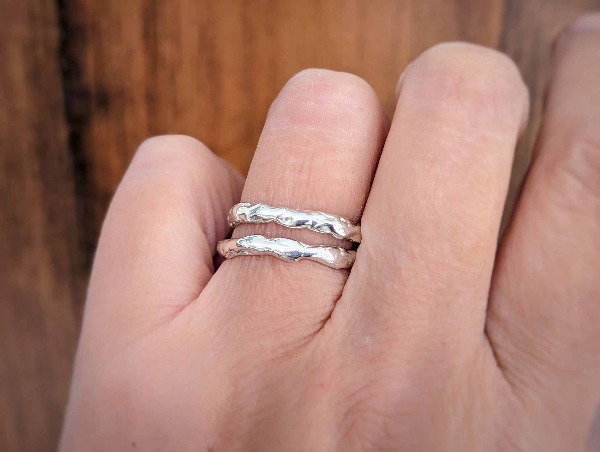 Set of 2 Solid Sterling Silver molten textured bands on a hand