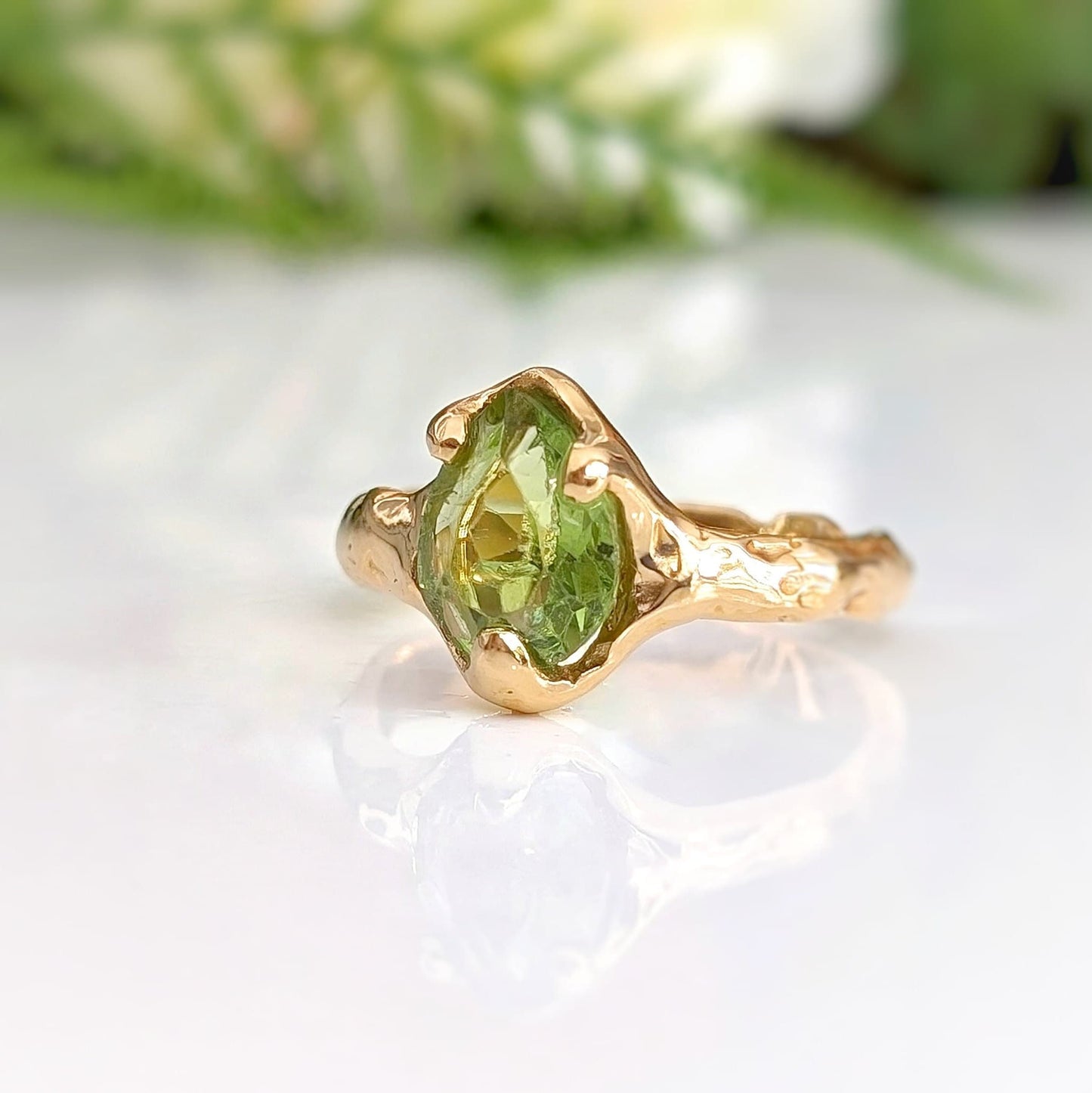 Large Pear shape Peridot set by prongs on a textured Molten Solid 14k Gold band