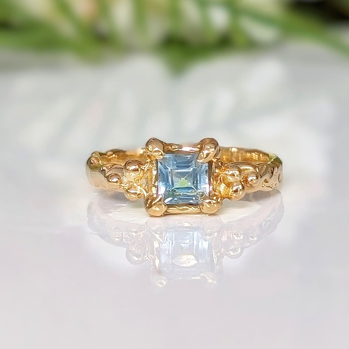 Square Blue Topaz set by prongs on a Solid 14k Gold Molten textured band
