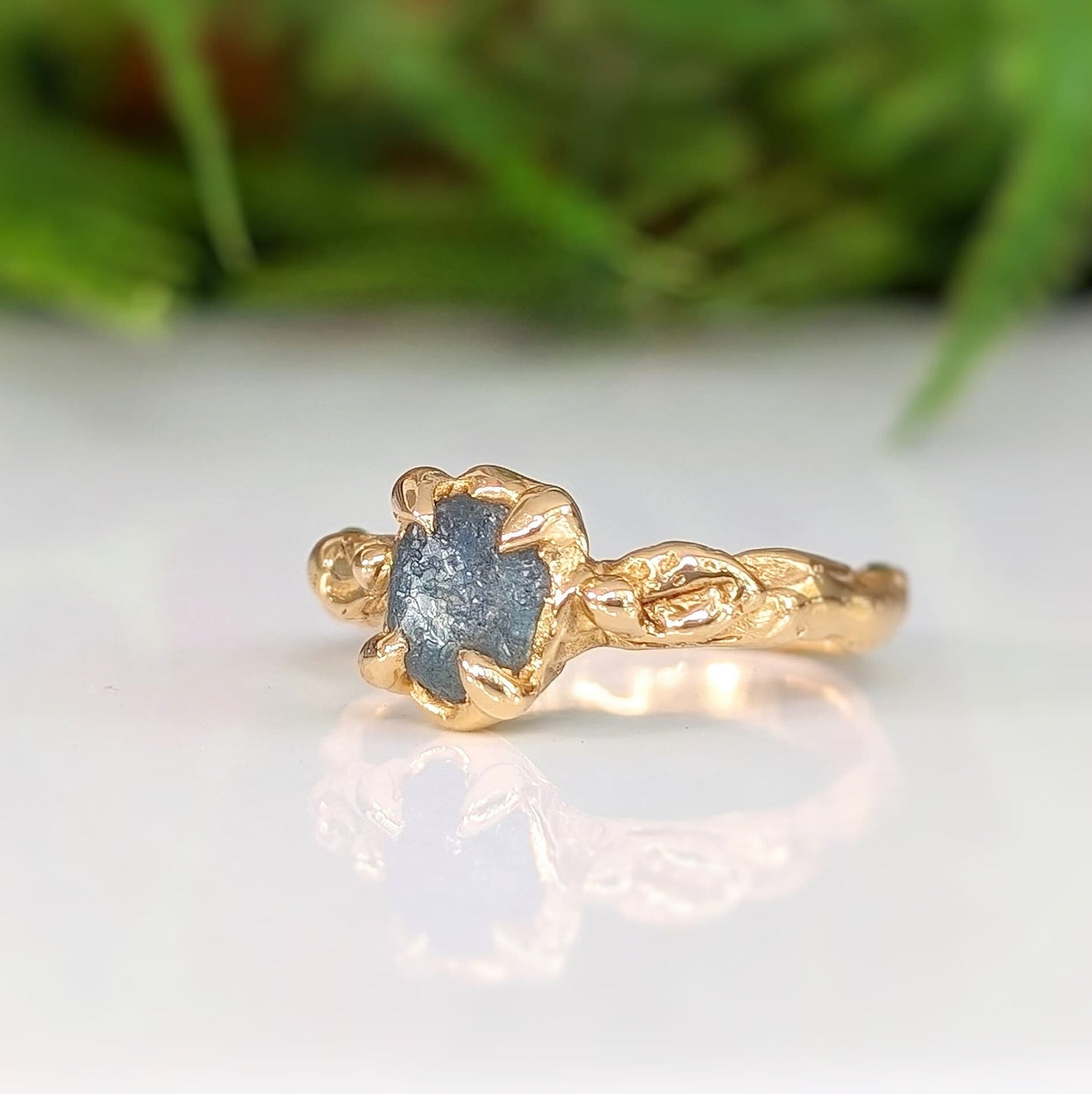Raw Montana Sapphire set by prongs on a textured Solid 14k Gold band