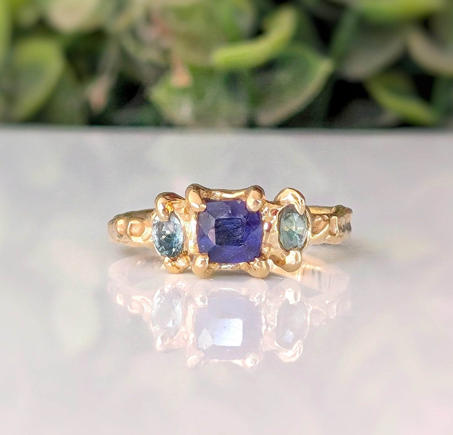 Square Blue Sapphire and 2 small green Tourmaline set by prongs on a textured Solid 14k Gold band