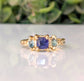 Square Blue Sapphire and 2 small green Tourmaline set by prongs on a textured Solid 14k Gold band