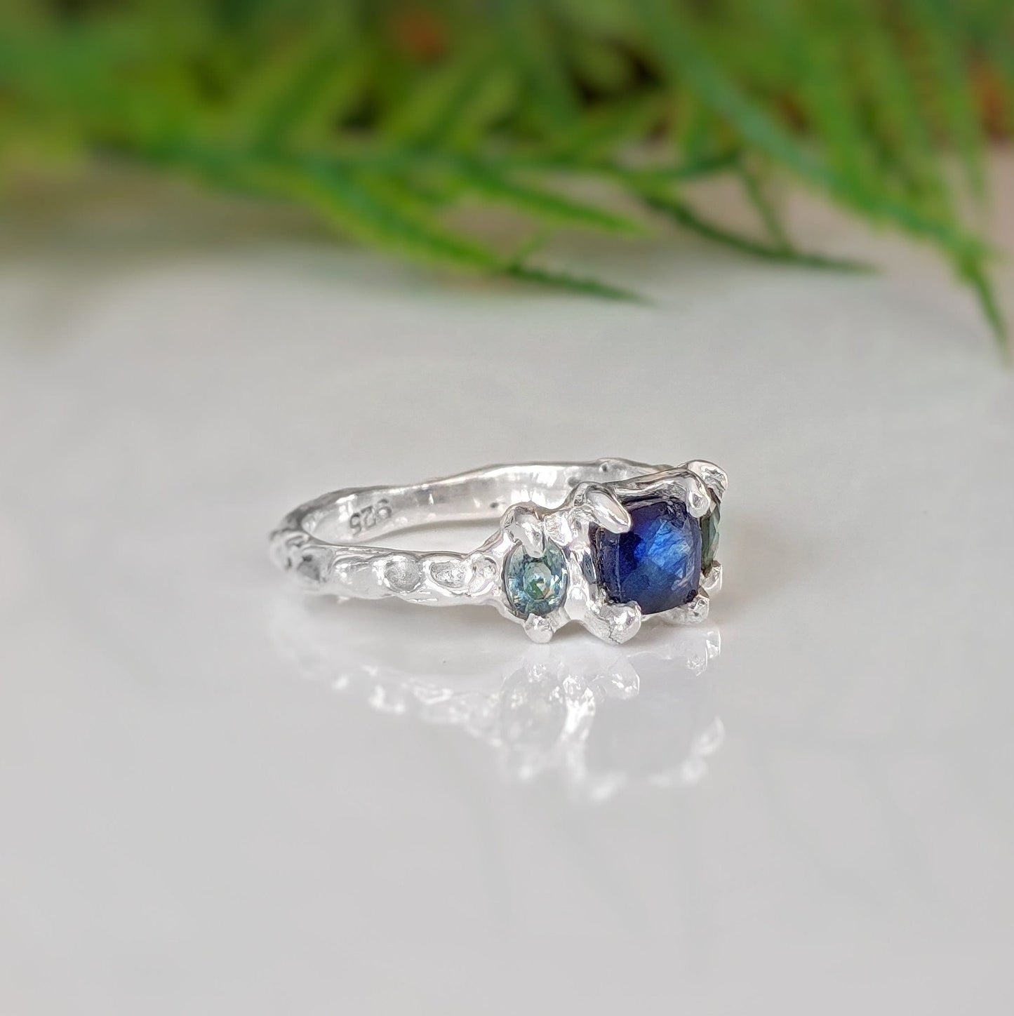 Square Blue Sapphire and 2 small green Tourmaline set by prongs on a textured Sterling Silver band