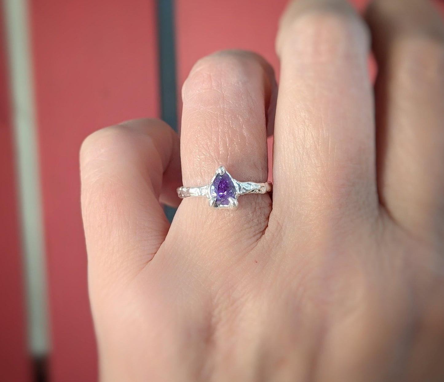 Pear shape Amethyst ring in Molten Silver setting on a woman's hand