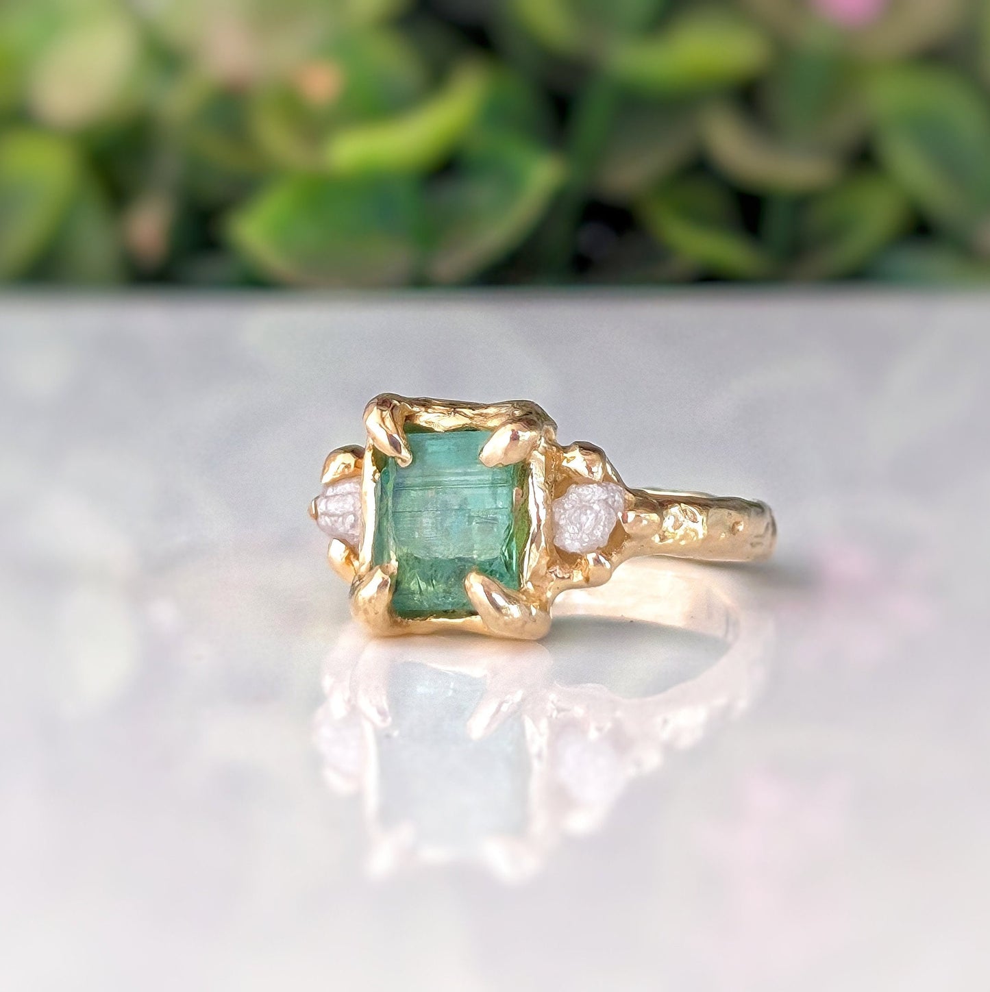 Raw mint green Emerald and diamonds set on Molten Gold prong setting